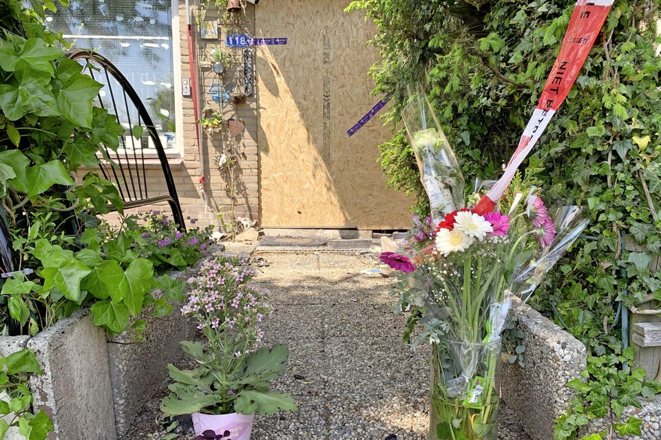 Een paar bossen bloemen staan zondagmiddag voor de deur van het huis aan de Lutherhof waar twee bewoners overleden door brand.