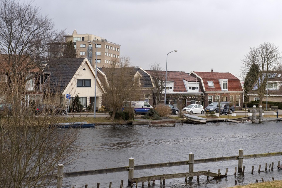 Het beeld van Oude Meer en Aalsmeerderbrug: traditionele dijkhuizen langs de Ringvaart met oprukkende bedrijventerreinen er achter.
