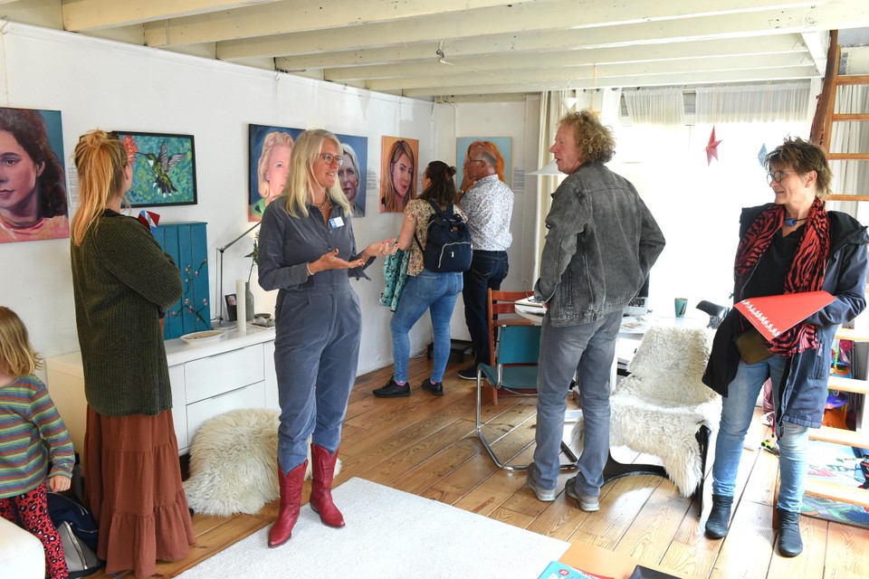 Kunstenaar Marieke Warmeling (midden met rode laarzen) geeft uitleg aan bezoekers.