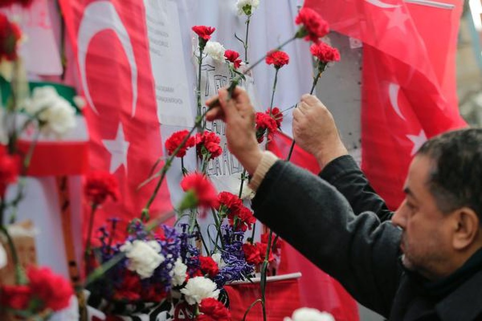 People lay flowers on a makeshift memorial at the location of the blast of a suicide attack on Istiklal Street, a major shopping and tourist district, in central Istanbul, on March 20, 2016. Three Israelis and one Iranian were killed, and 39 people injured, when the bomber blew himself up March 19 on Istiklal Street, less than a week after another deadly attack left 35 dead in Ankara. A Turkish jihadist with links to the Islamic State carried out the suicide bombing that killed four foreigners on a major shopping street in Istanbul, Interior Minister Efken Ala said March 20. / AFP PHOTO / YASIN AKGUL Horizontal ORG XMIT: 5612