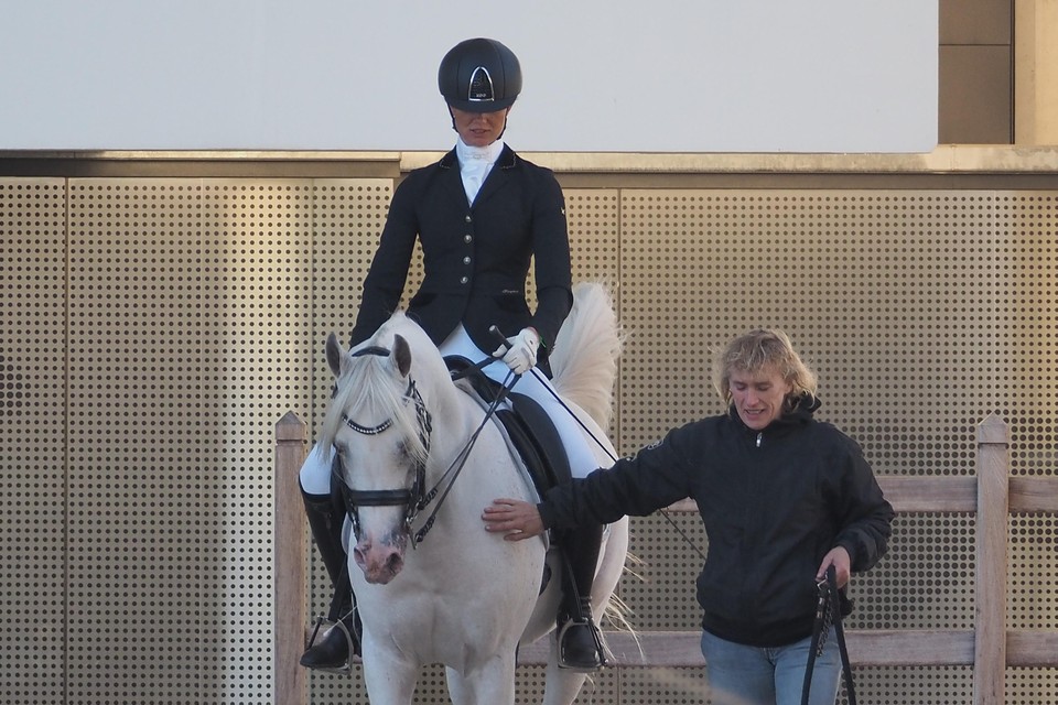 Saskia Rutte en Fayyim op weg naar de wedstrijdring. Miriam van Heiningen, eigenares van het paard, loopt mee.