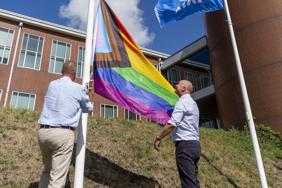 Hans van den Berg (r) en André Blankman hijsen de pride-vlag.